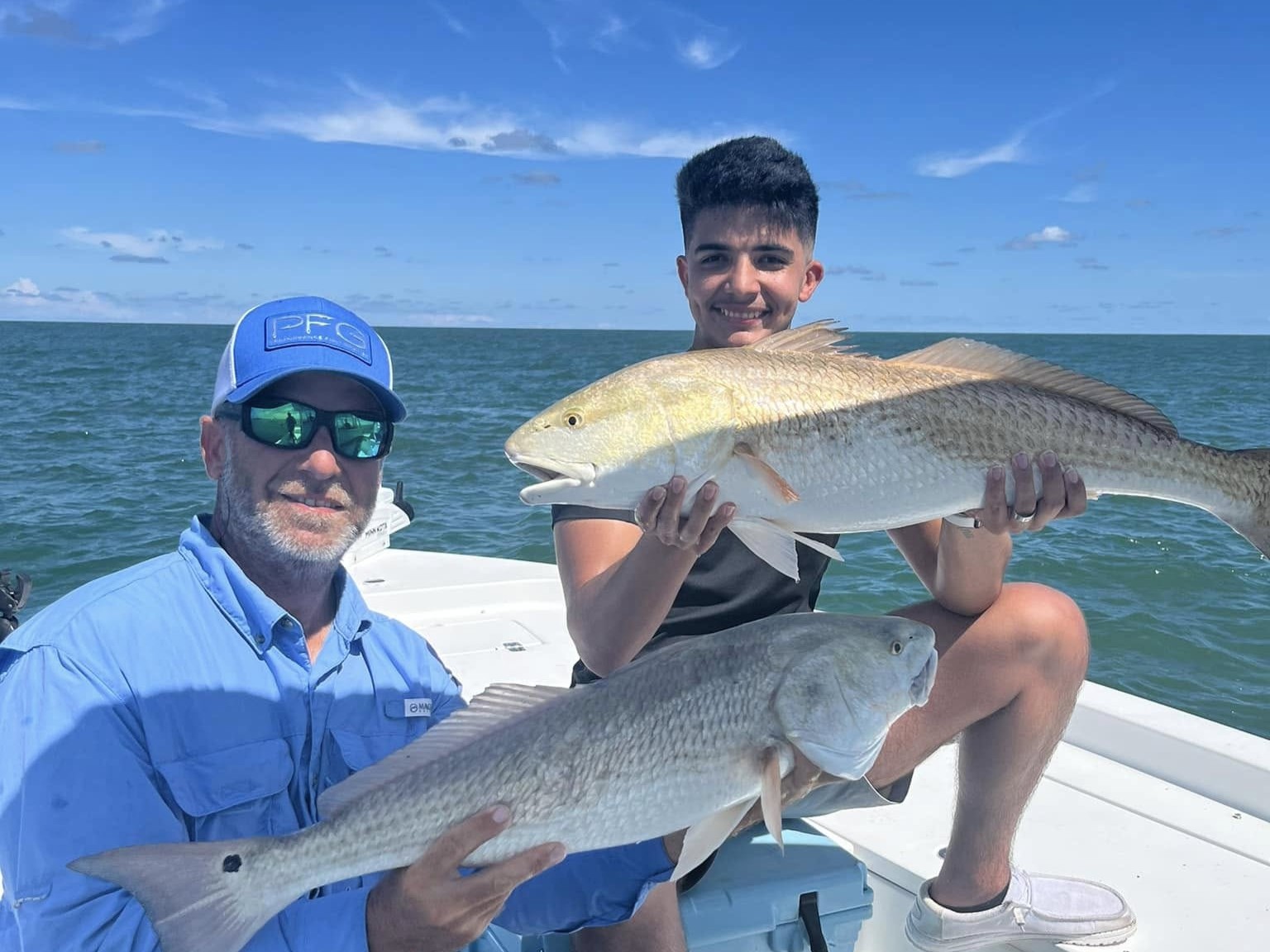 Family fishing charter boat on calm waters near New Smyrna Beach with parents and kids