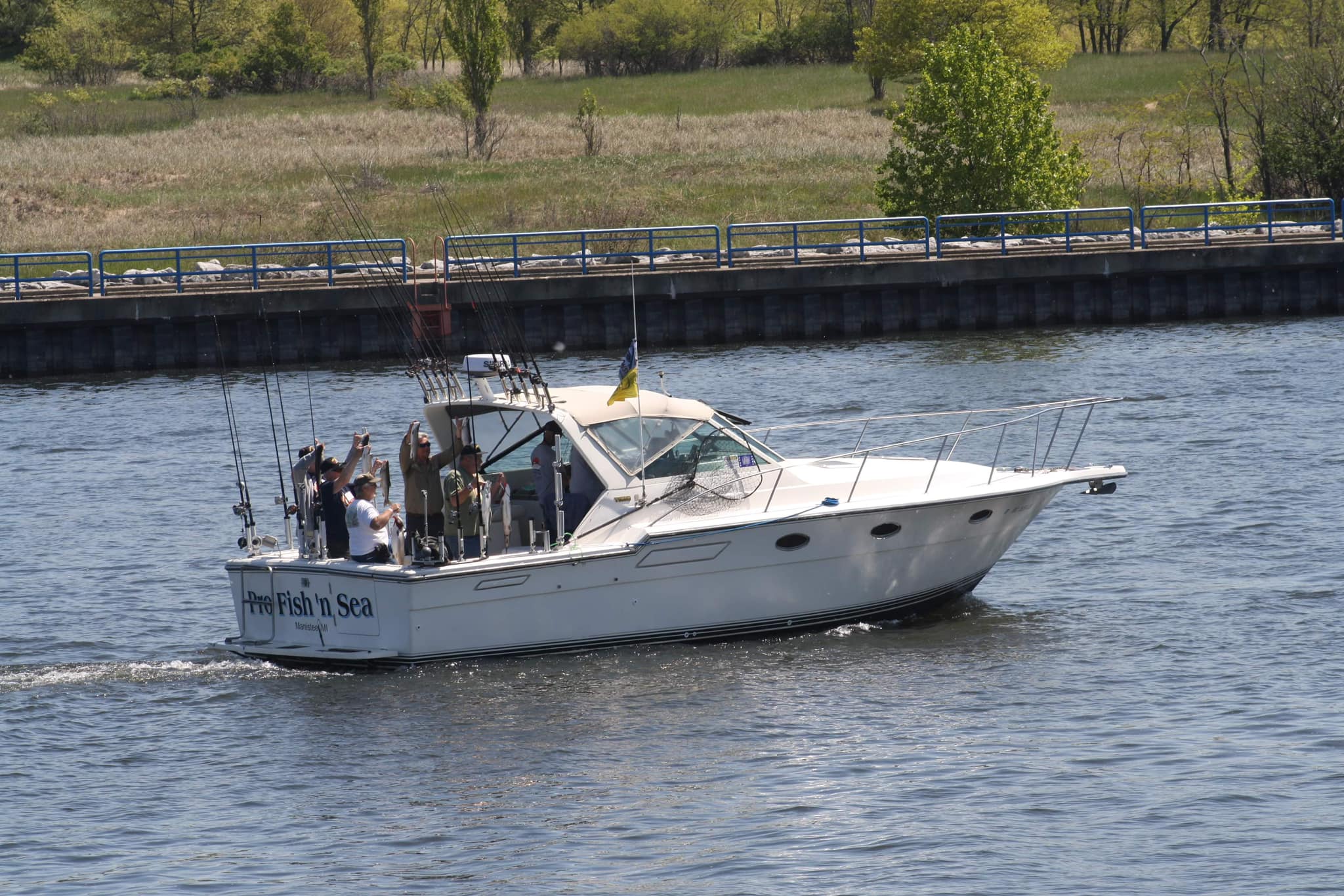 Three people enjoying a fishing trip in Manistee