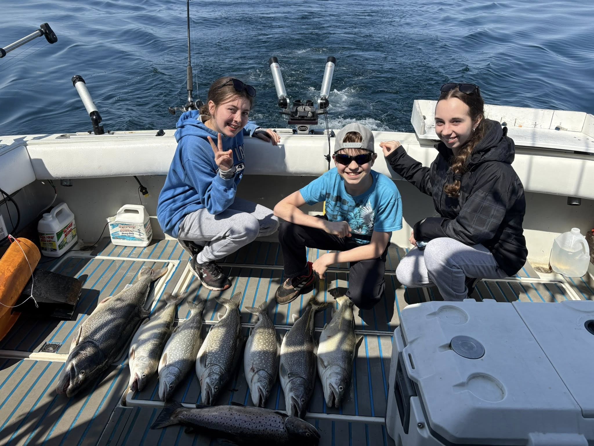 Successful lake trout fishing trip in Mexico NY with multiple fish displayed on boat deck