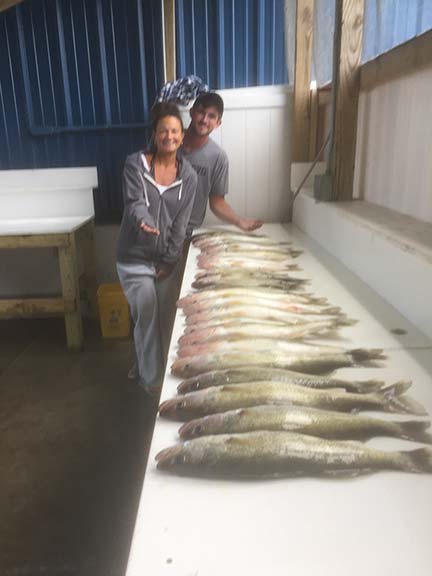 A fisherman holds a large 45-inch fish in MI