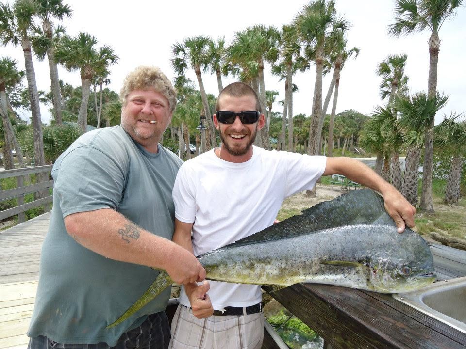 Fresh caught Mahi Mahi displayed on dock with palm trees in Sebastian FL