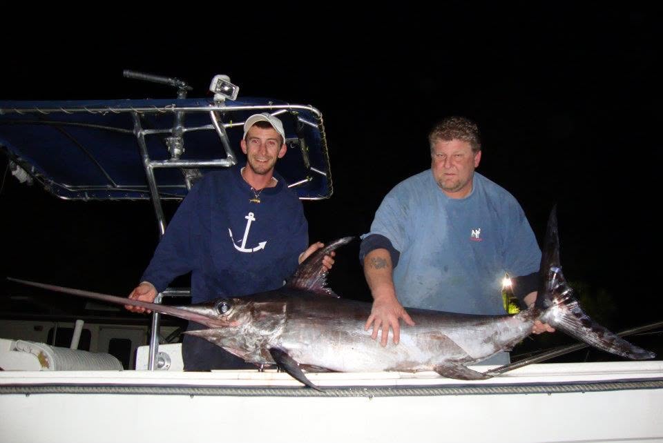 Swordfish catch displayed on boat deck at night in Sebastian FL