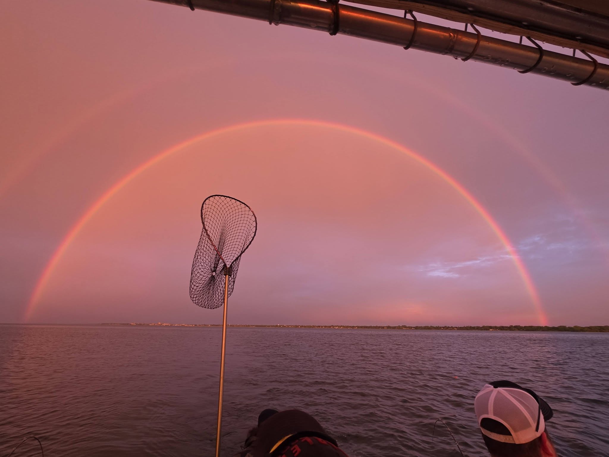 Fishing net on boat with rainbow over water in Racine WI