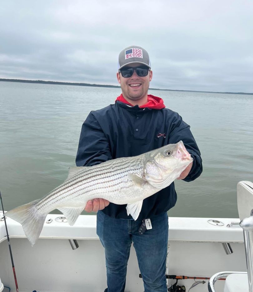 A fisherman catches a striped bass in Saint Leonard