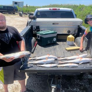 A fisherman holds a 22-inch catch in NC