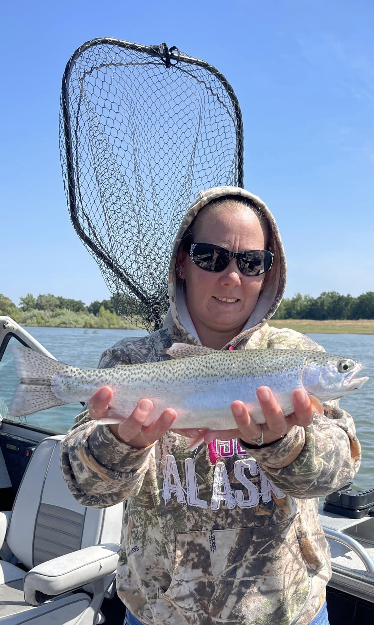 Photograph of a fisherman catching a 19-inch rainbow trout in CA