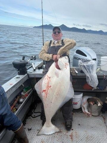 Large Pacific halibut caught while fishing in Chugiak Alaska on boat deck