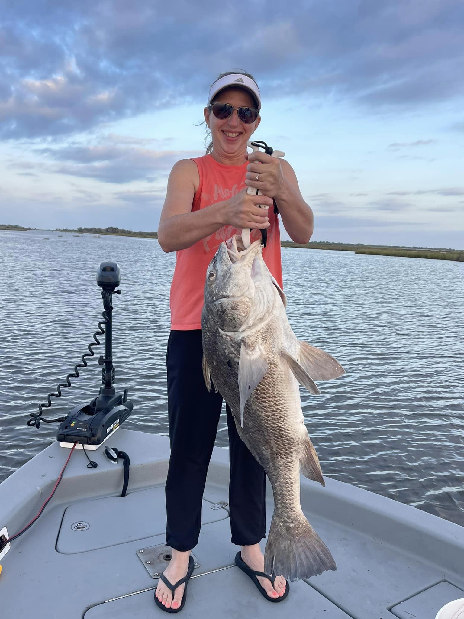 Fisherman with a large black drum fish in LA