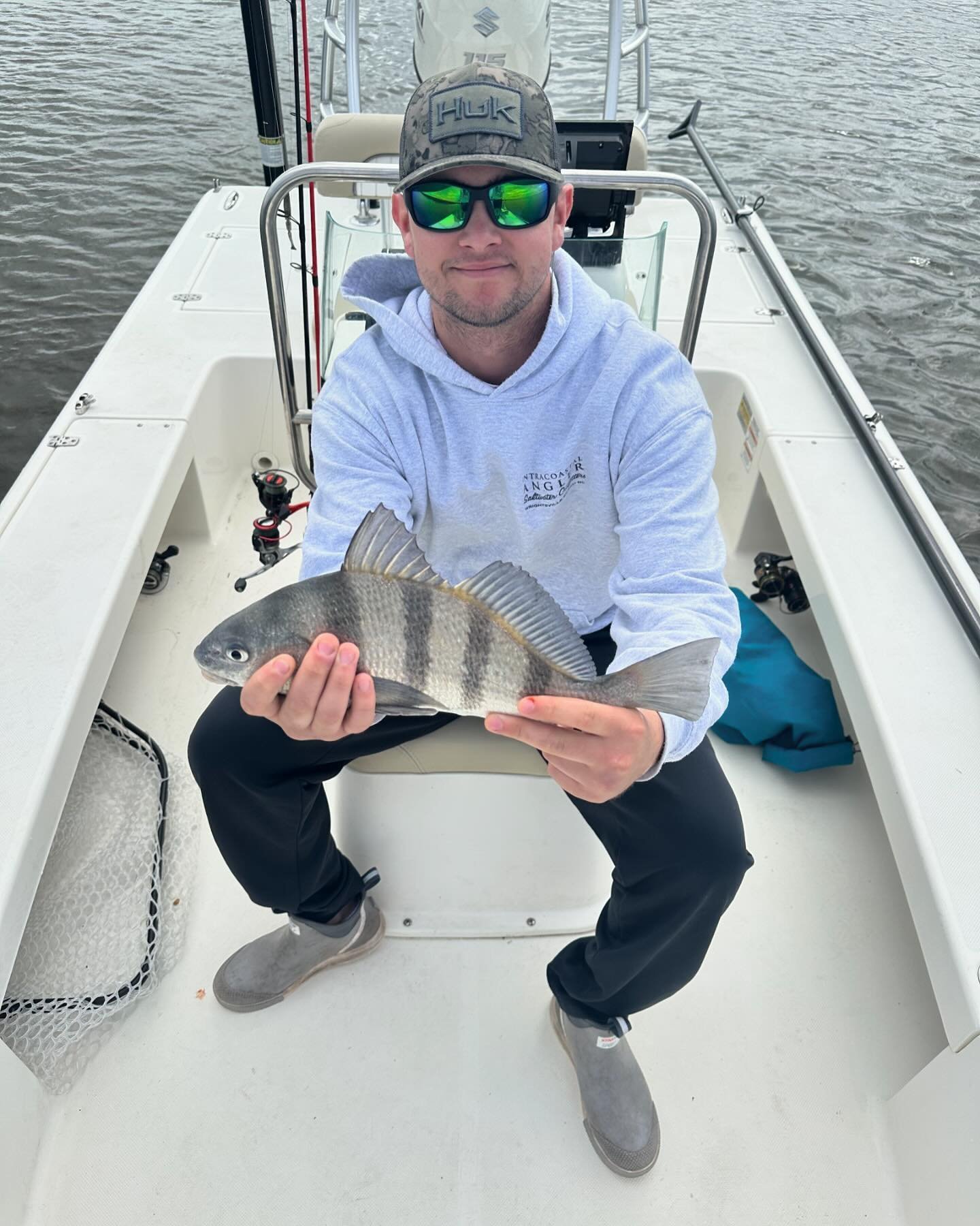 A fisherman catches a black drum fish in North Carolina