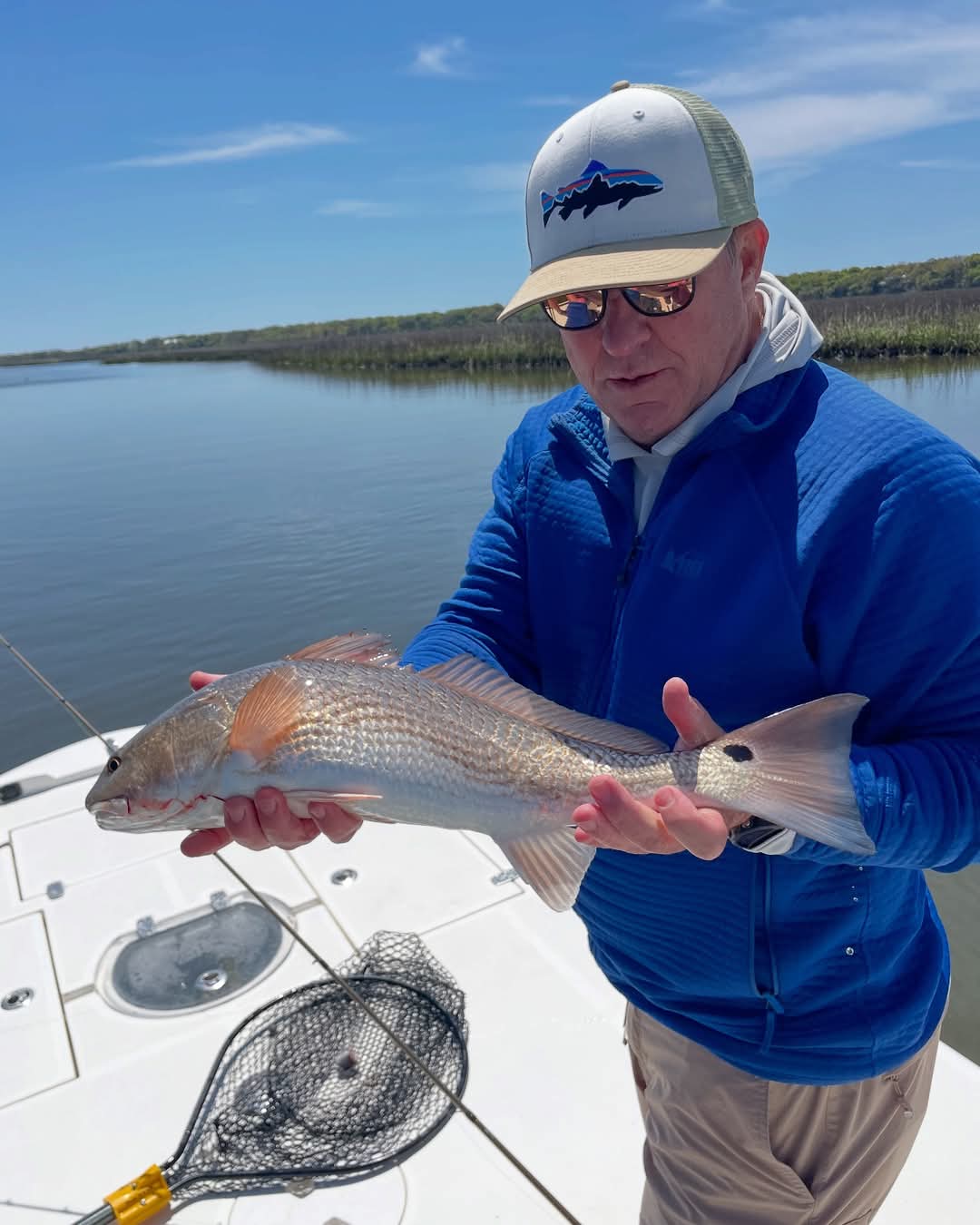 A fisherman reels in a catch in North Carolina.