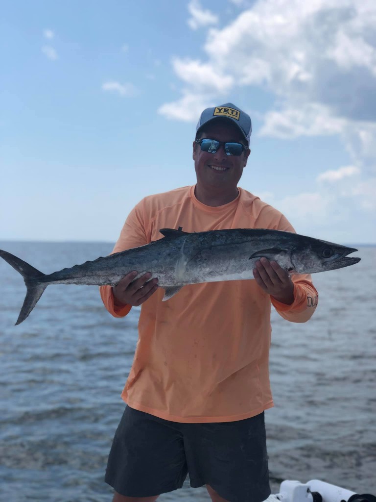 Catch of the day! Fisherman with a large king mackerel in Santa Rosa Beach