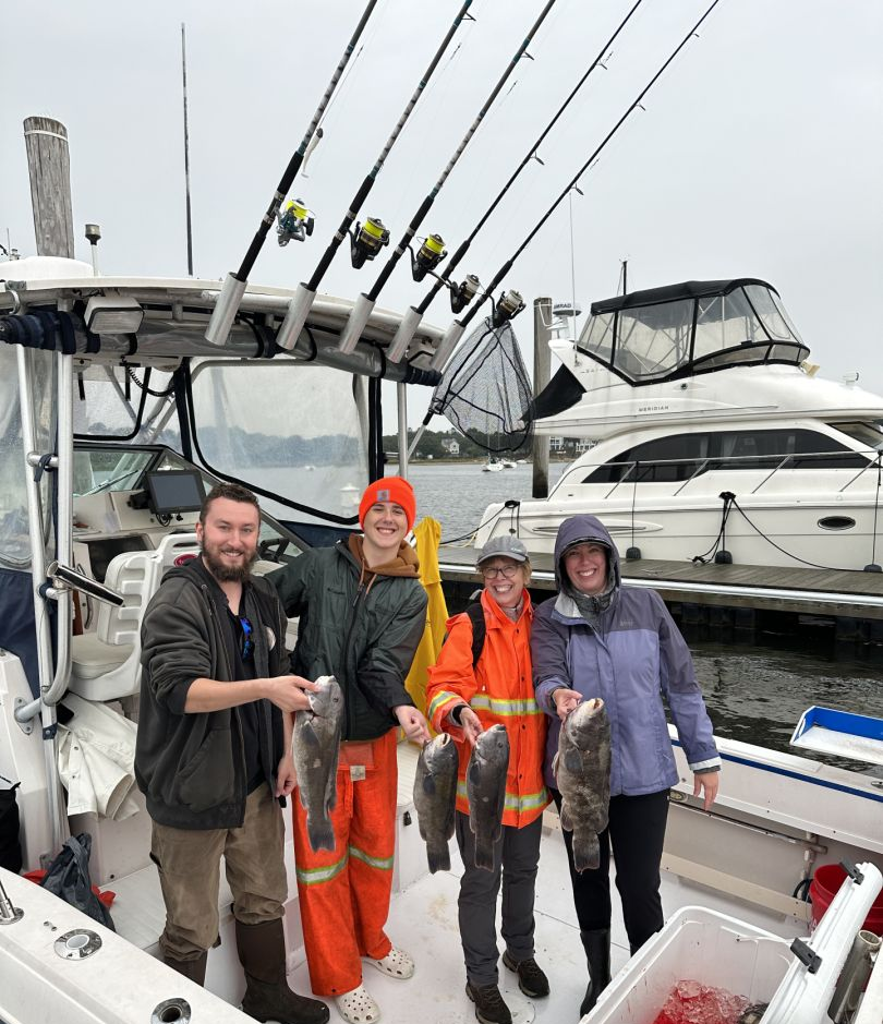 4 anglers holding their fishing rods and catch in MA