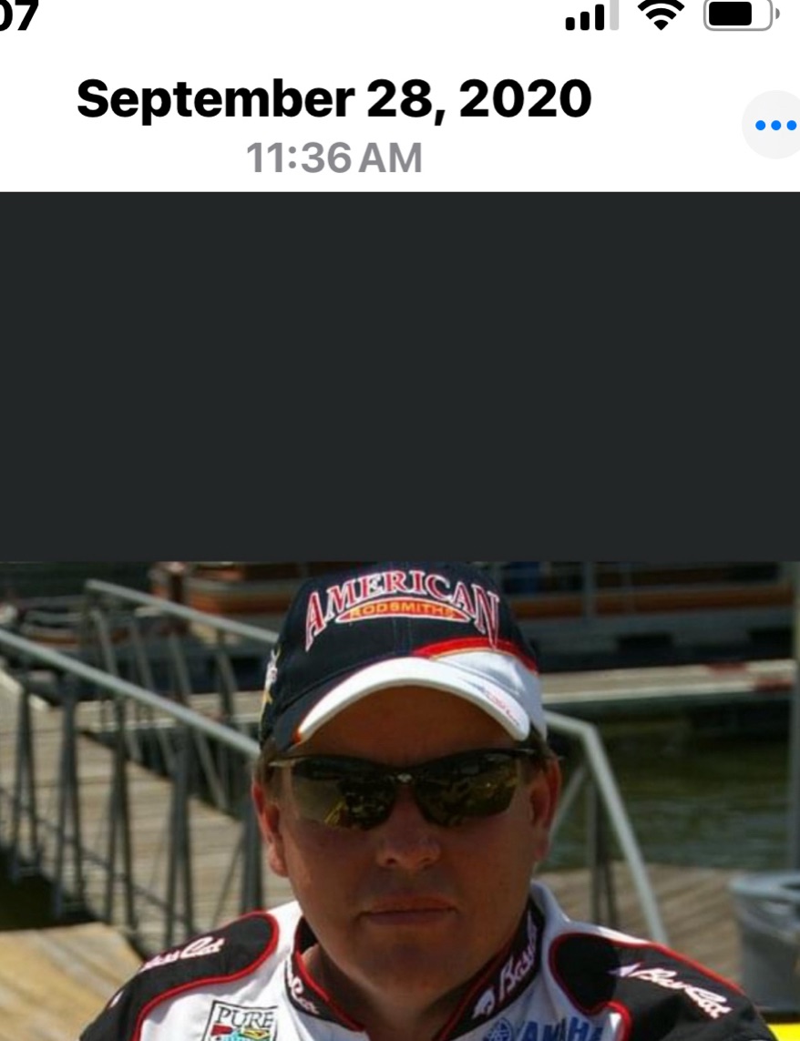 Fishing guide wearing sunglasses and visor at marina dock in Galveston TX