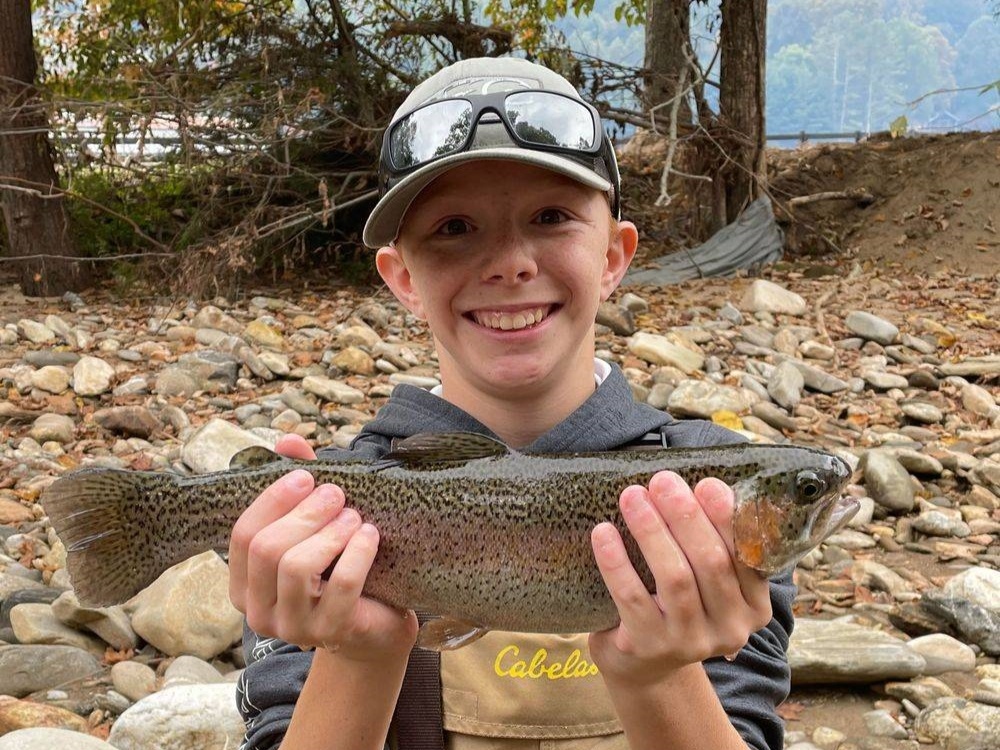 Angler with a rainbow trout caught in NC