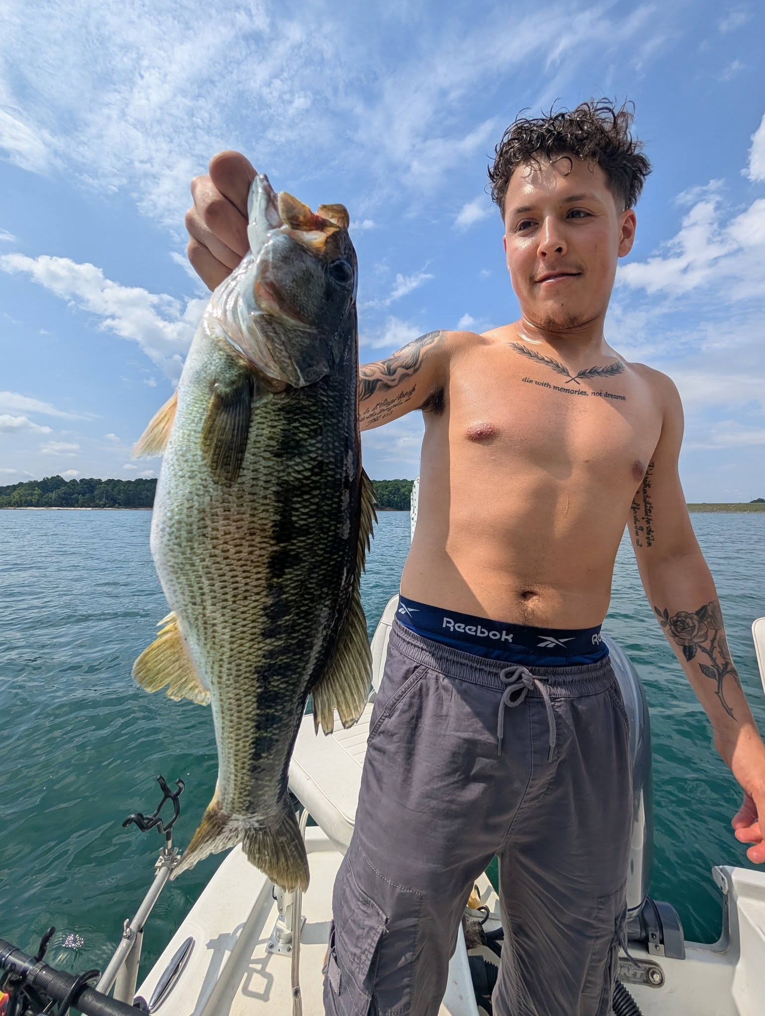 Spotted bass catch held up on fishing boat in Gainesville GA