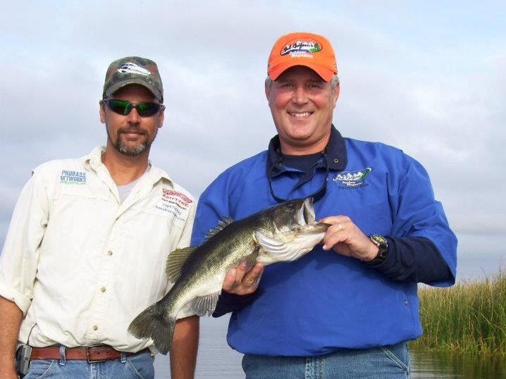 Two anglers fishing in Florida with a small fish