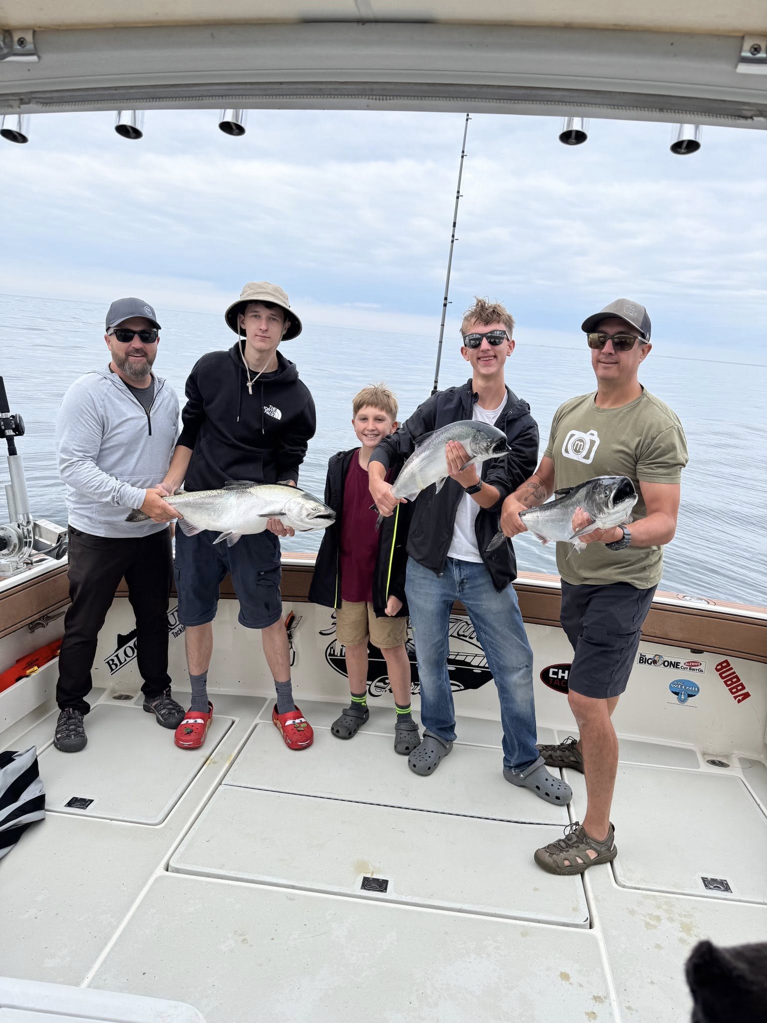 Successful fishing charter in Muskegon MI displaying fresh caught Chinook salmon on boat deck