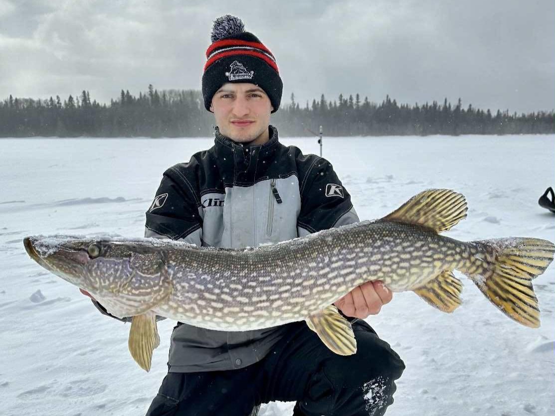 Guided fishing trip on Kapuskasing River with anglers in 14-foot Lund boat casting for fish