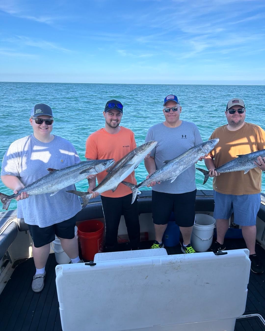 Four anglers displaying their catch of King Mackerel and Cobia on fishing boat in Sebastian FL waters
