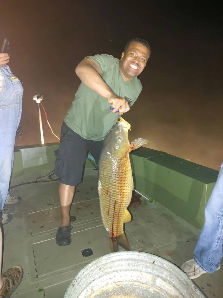 A single fisherman reeling in a 23-inch catch in Missouri