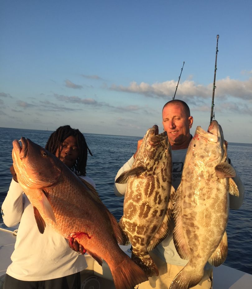 Three black grouper, 33 inches long, caught while fishing in Dania Beach