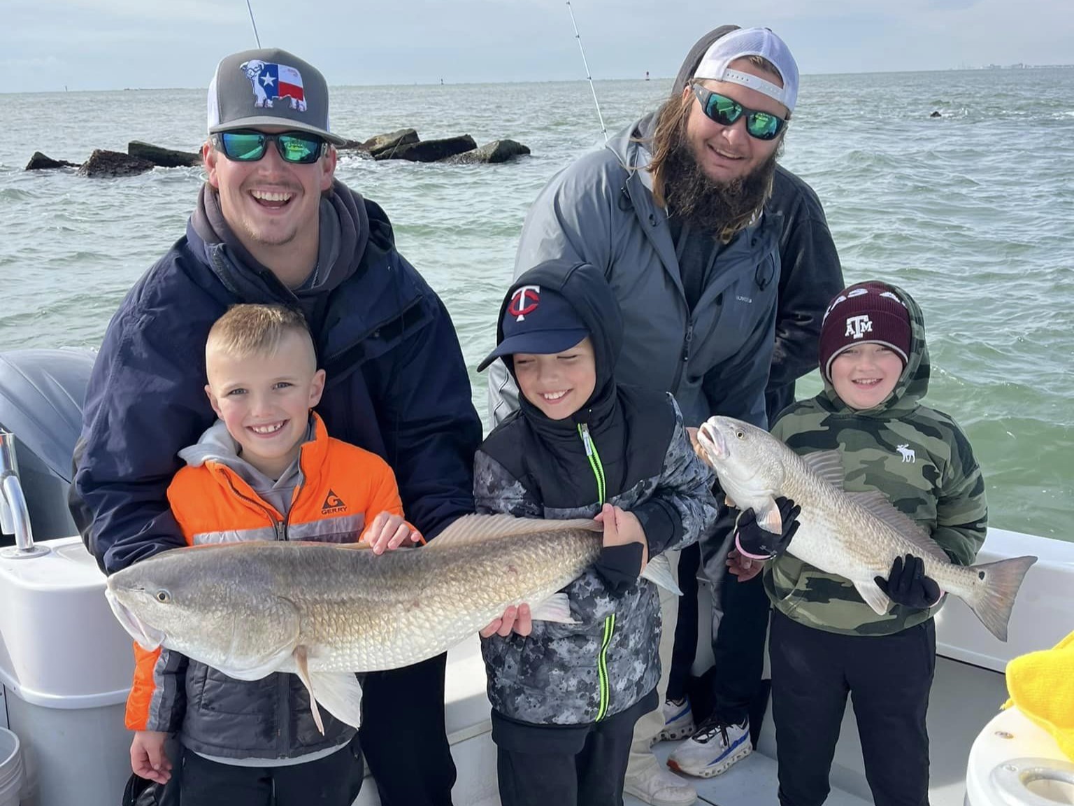 Two redfish being caught by fishing enthusiasts in TX