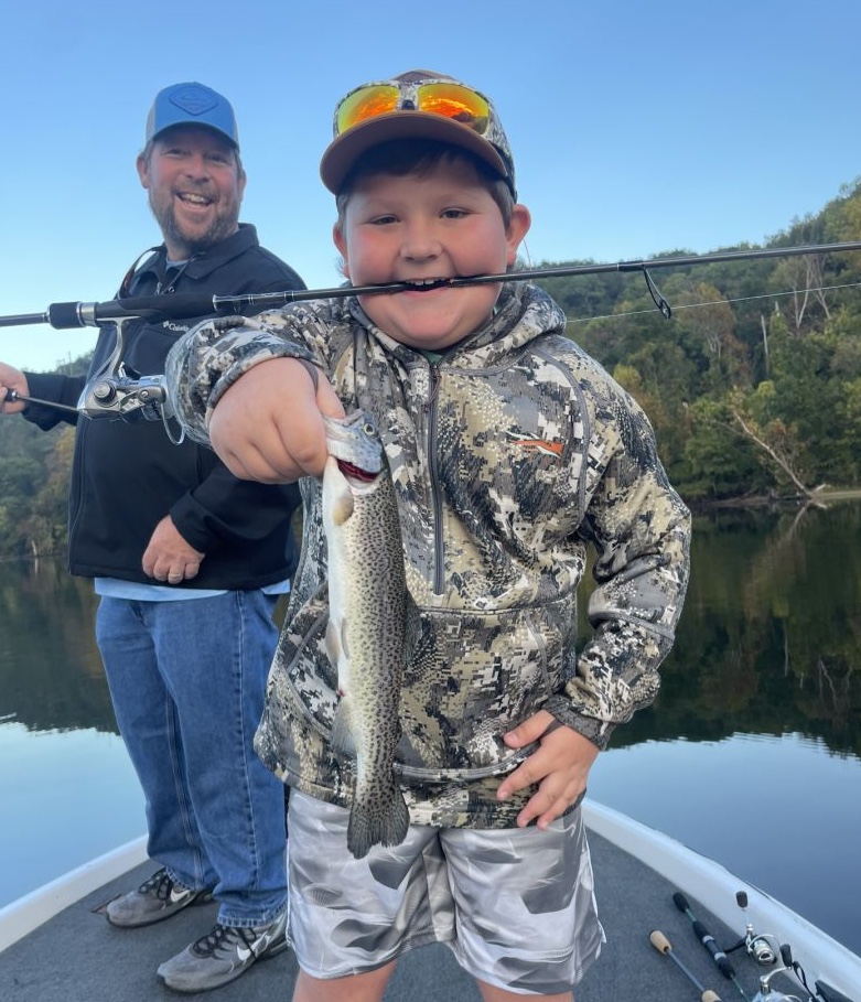 Angler holding large rainbow trout in Branson