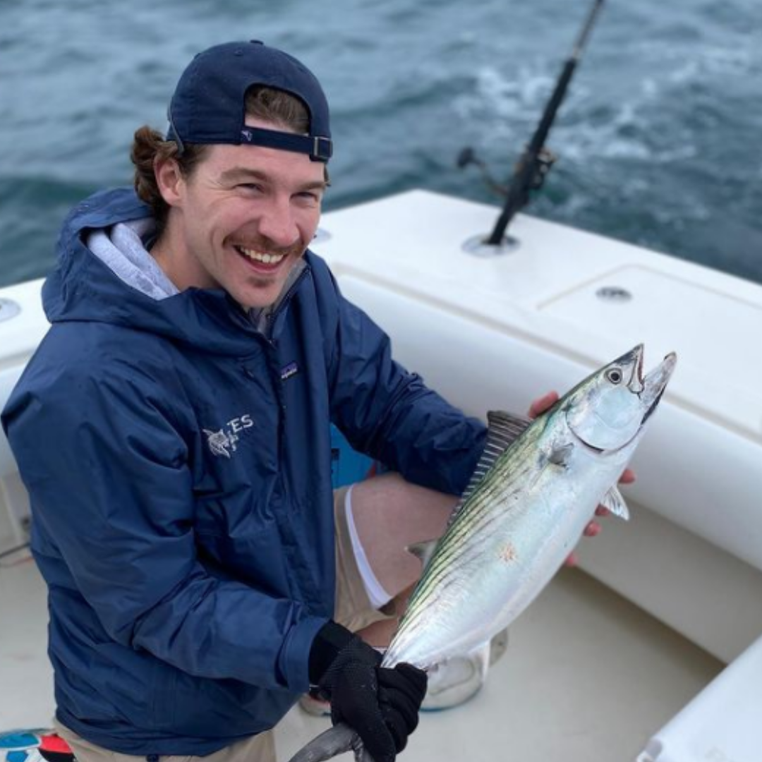 One fishing person catches a fish in MA