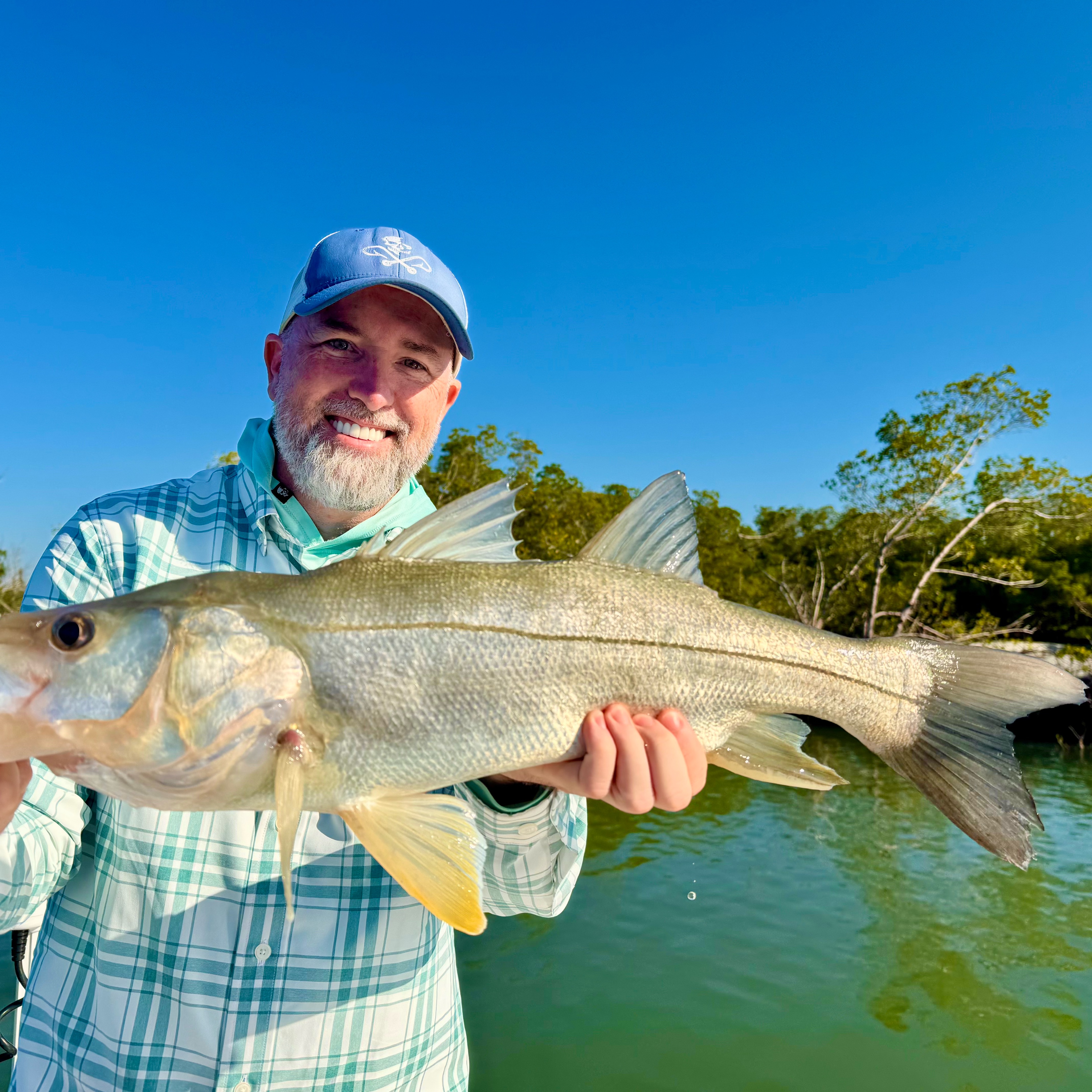 Photo of a snook fish being caught while fishing in FL