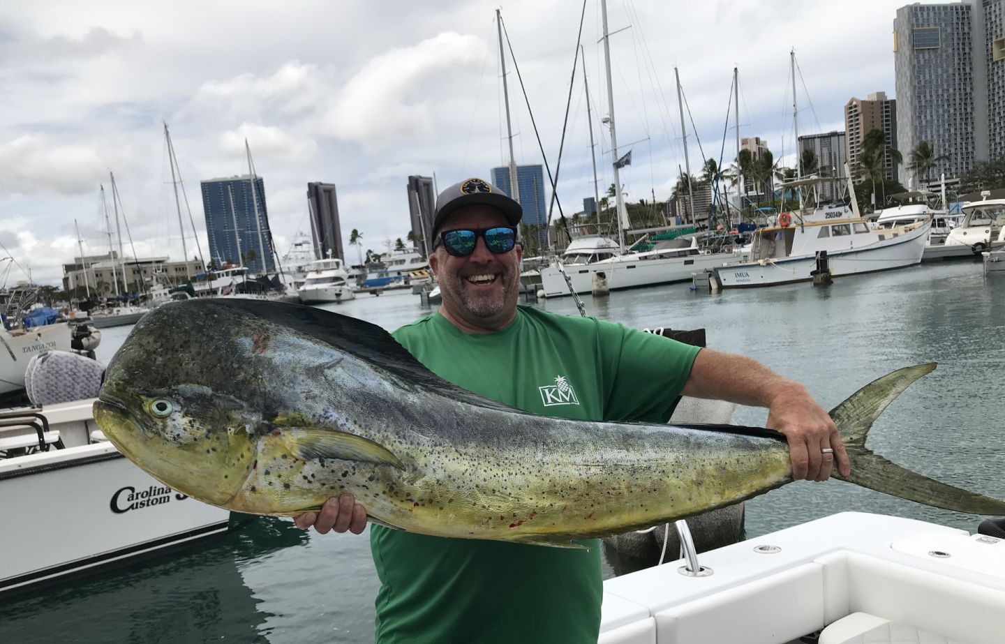 A lone angler fishing in the waters of Honolulu