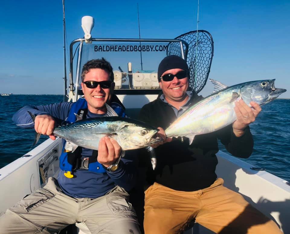 Two anglers enjoying a successful fishing trip in NC