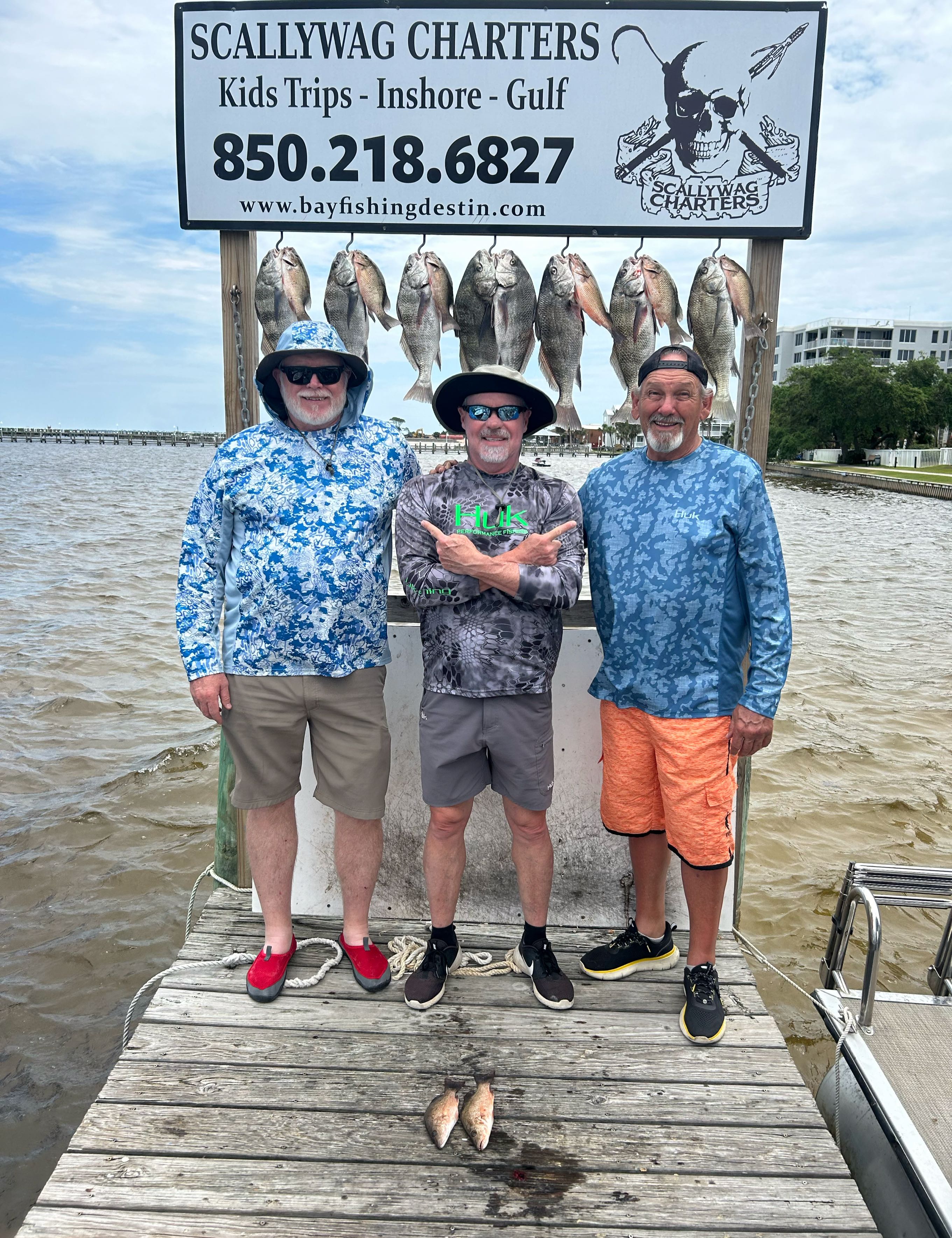 Two black drum fish caught by three people in Fort Walton Beach