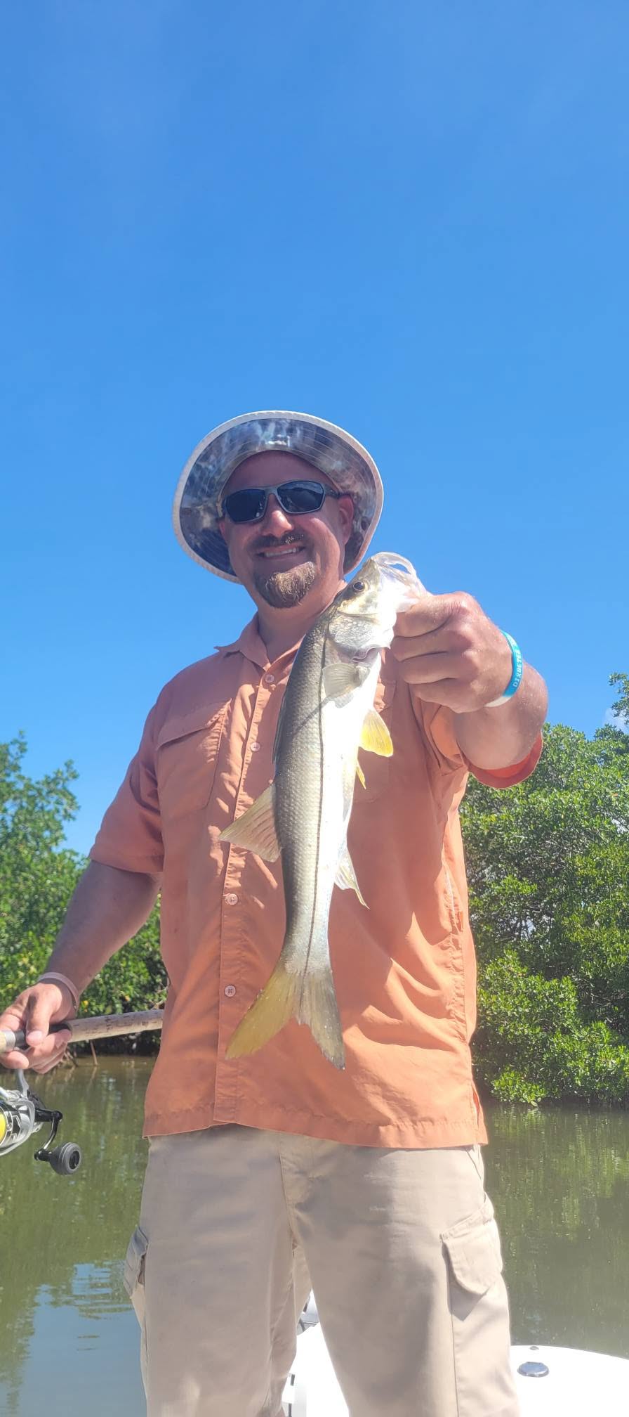 Angler holding freshly caught snook fish in Bonita Springs Florida