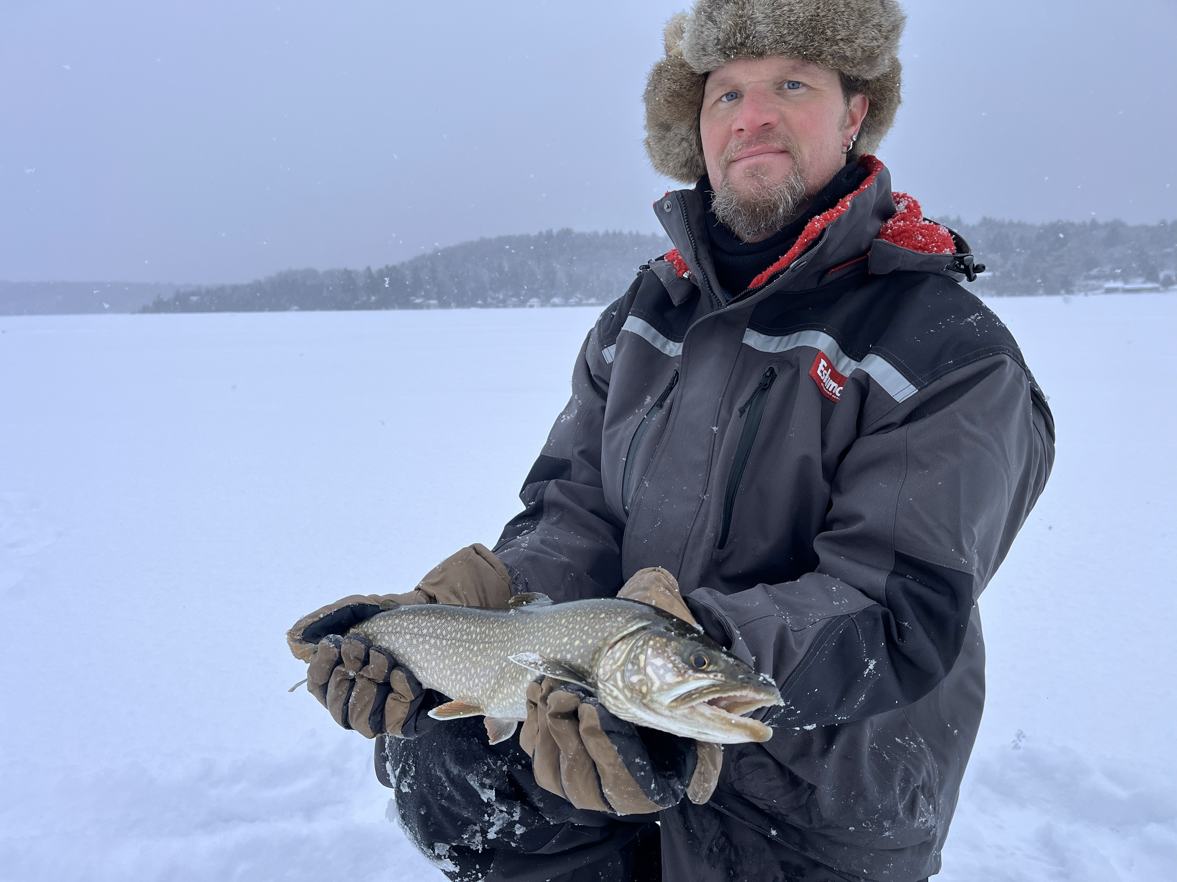 A lone fisherman catches a lake trout in Evans Mills