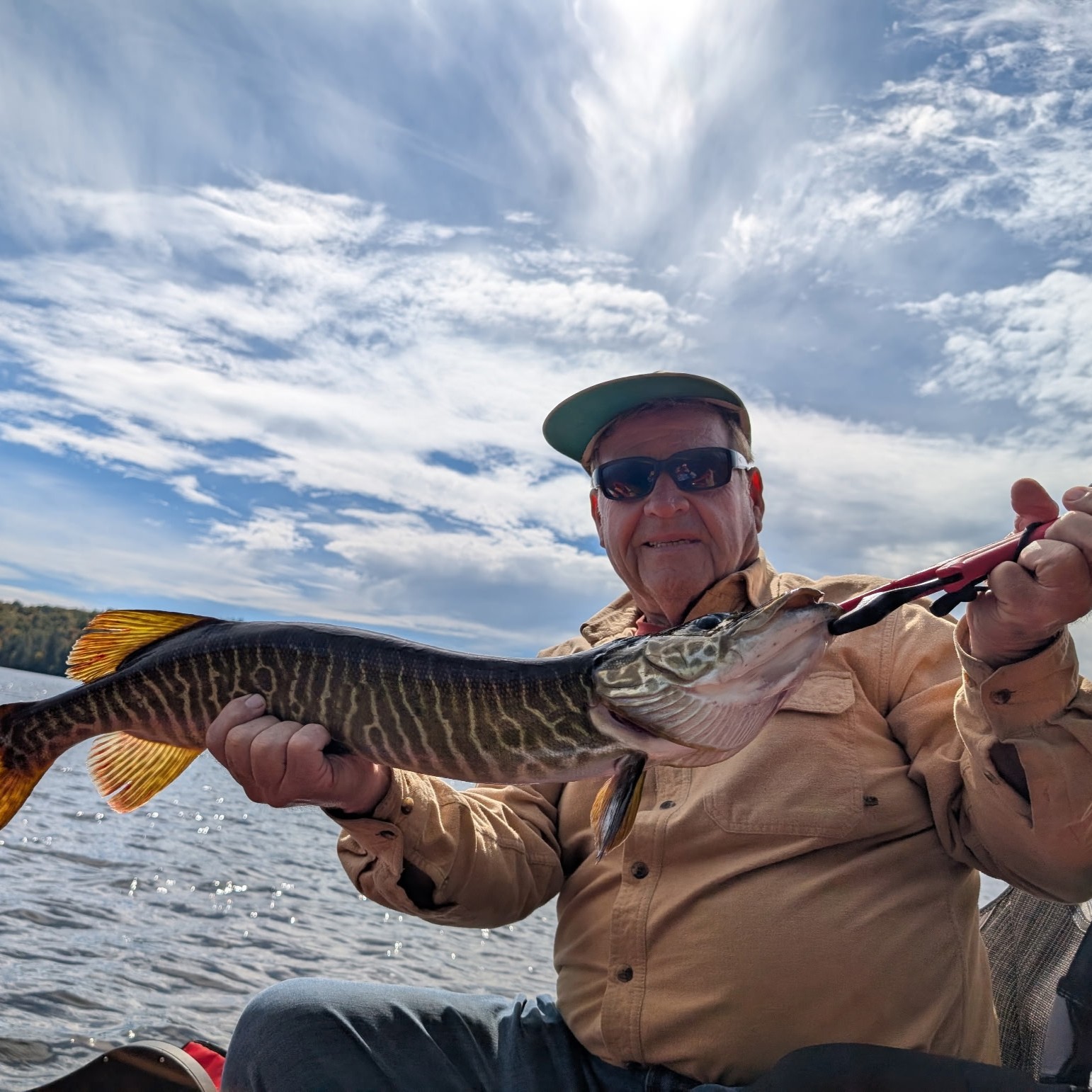 Guided ice fishing for trophy Tiger Musky on frozen lake in Upstate New York near Fort Drum