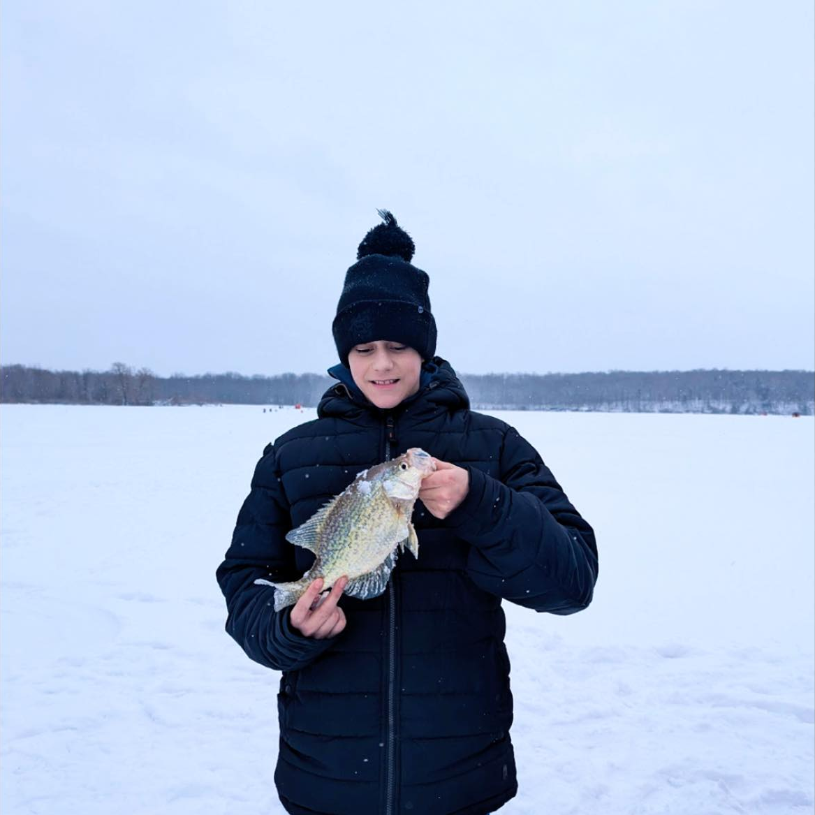 Private guided ice fishing for crappie and perch on frozen lake in upstate New York