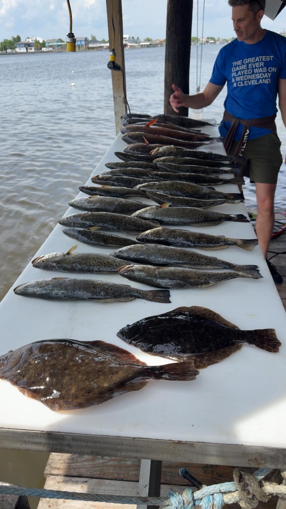 Fishing catch display showing summer flounder and speckled trout on boat table in Lafitte Louisiana