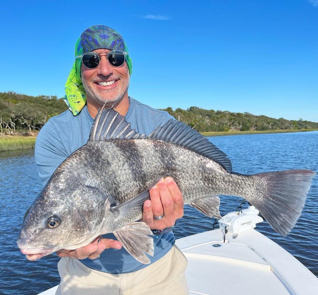 Angler with a large black drum fish in FL