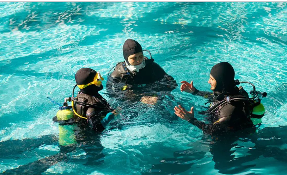 Scuba diver practicing skills in pool during refresher course in Florida Keys