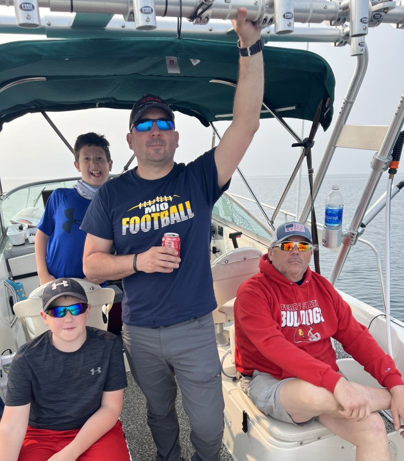 Four anglers posing in Harrisville with their fishing gear