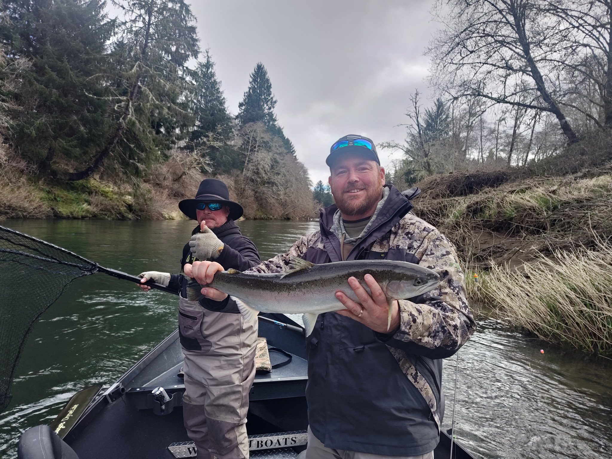 Coho salmon caught during fishing tour in Lincoln City OR with fishing boat on river