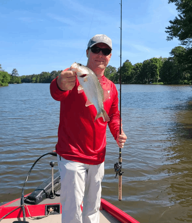 Angler holding a 12-inch fish in Virginia Beach