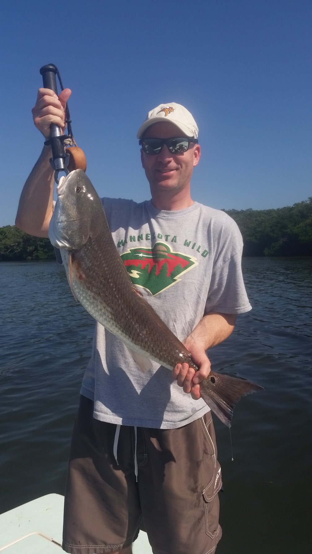 Fisherman holding a 17-inch catch in St. Petersburg