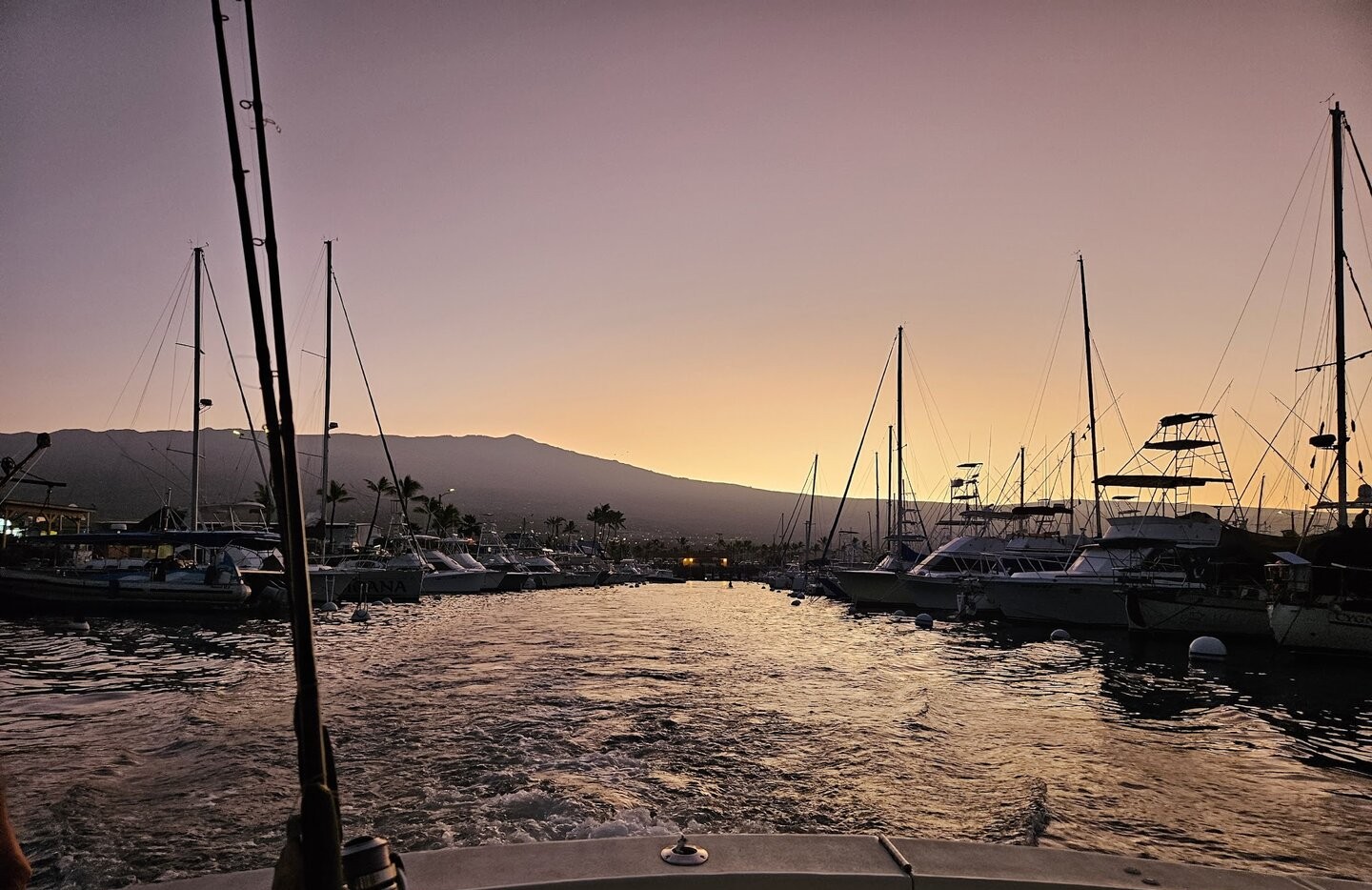 Memorial ash scattering charter boat on calm Kona Coast waters for peaceful farewell ceremony