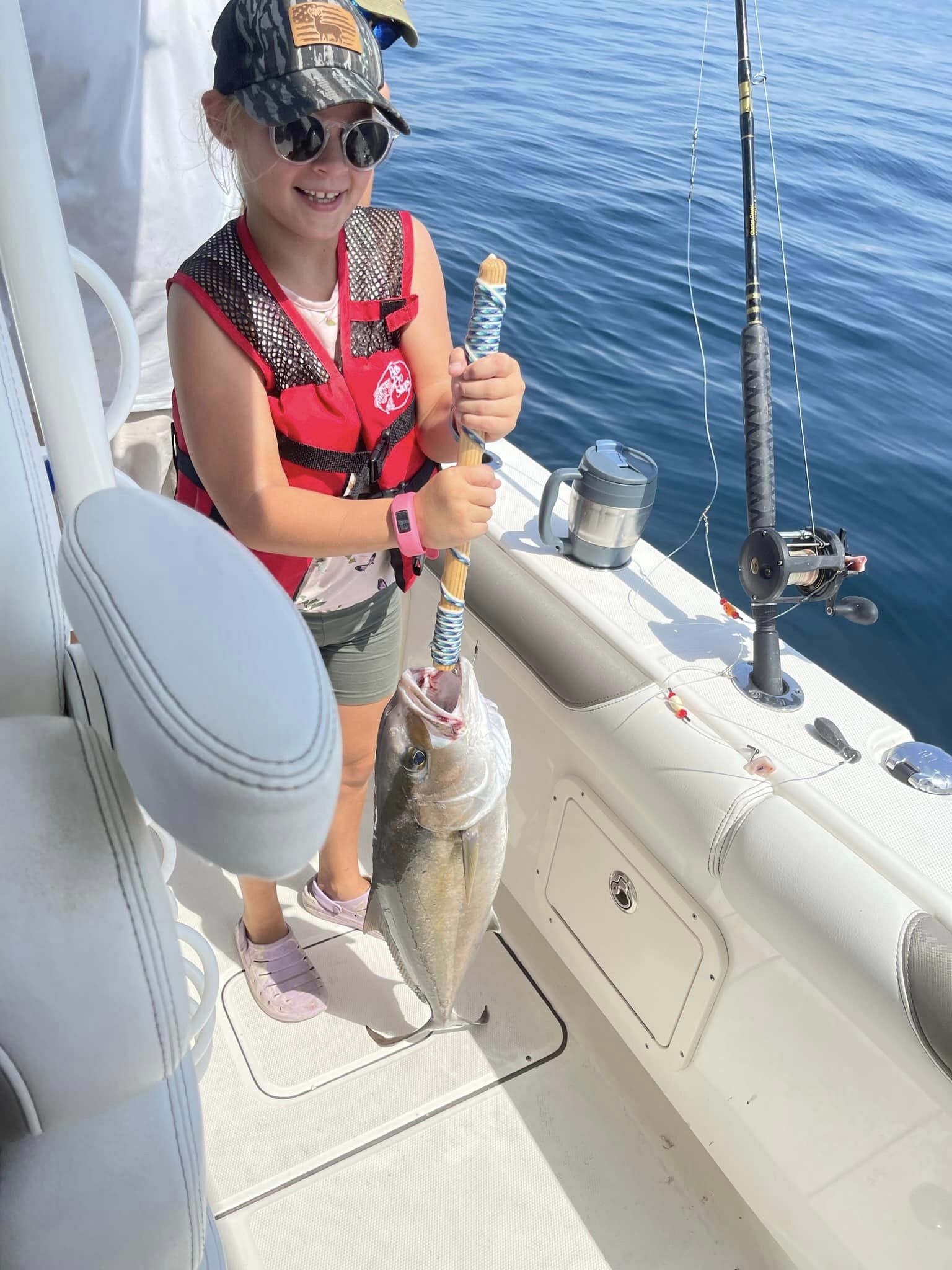An angler holding a 14-inch fish in Fort Walton Beach