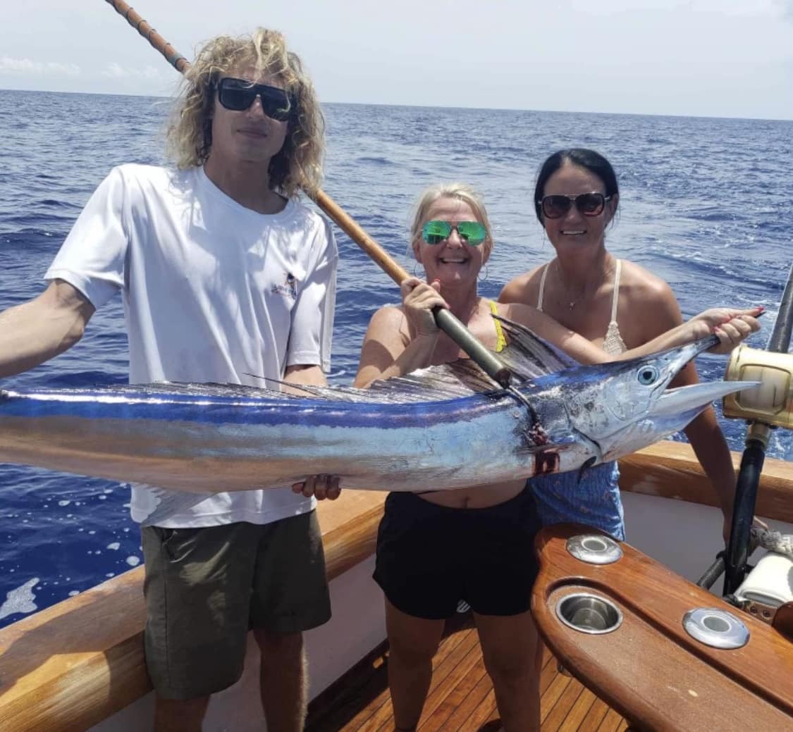 Three anglers with a fishing rod in Kailua-Kona