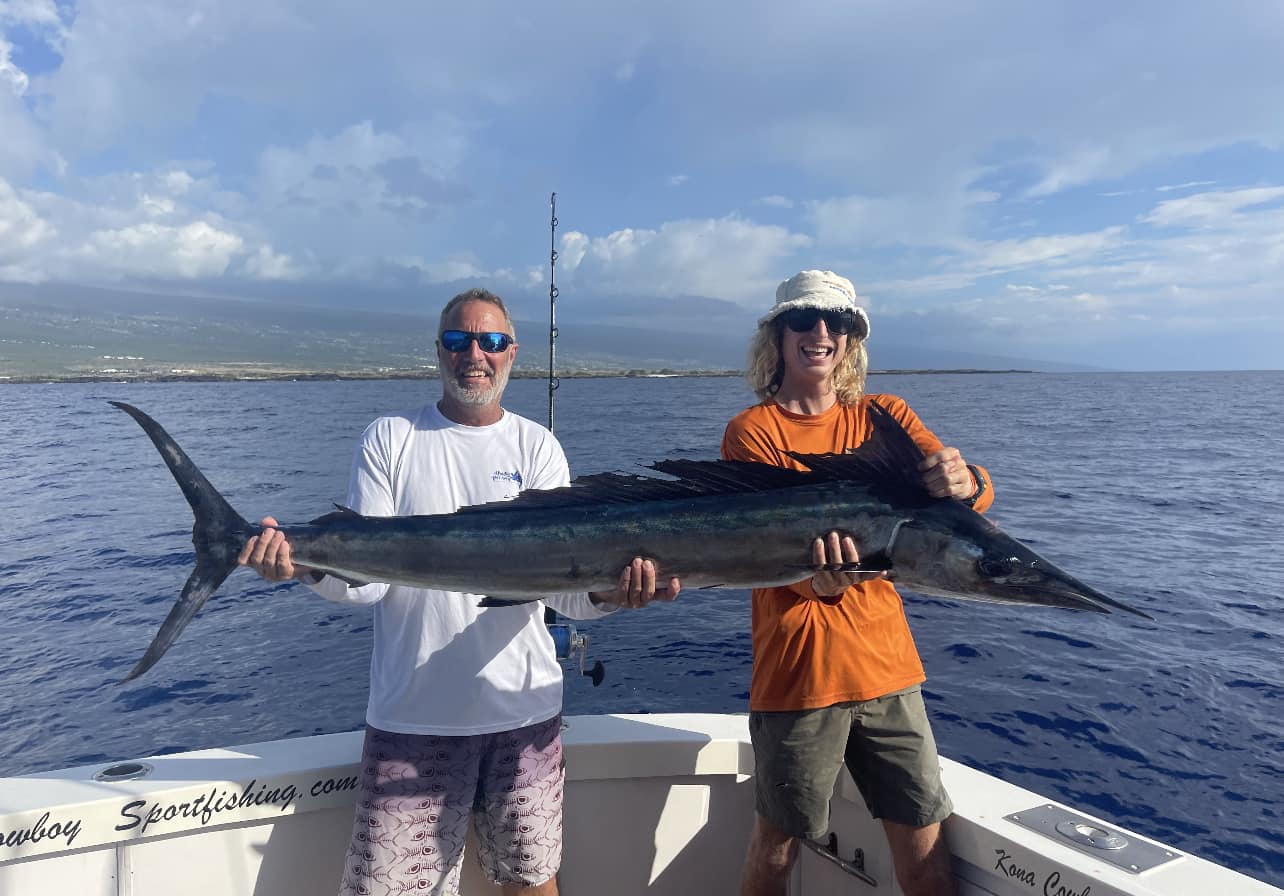 Two people fishing on the beach in Hawaii