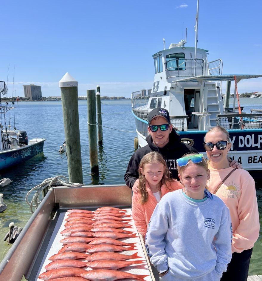 4 people at Pensacola Beach enjoying fishing