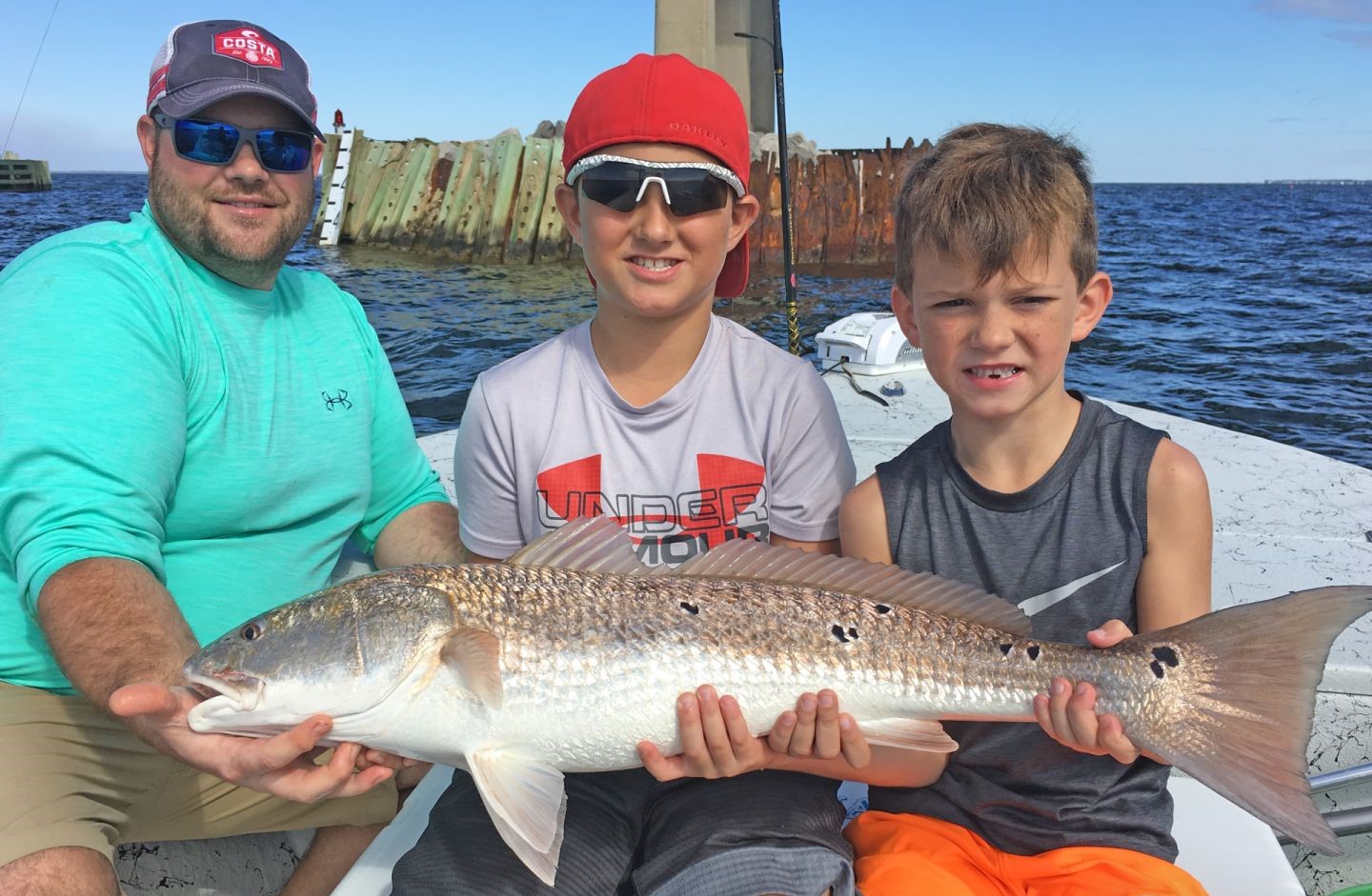 A redfish measuring 34 inches, caught by 3 people at Pensacola Beach