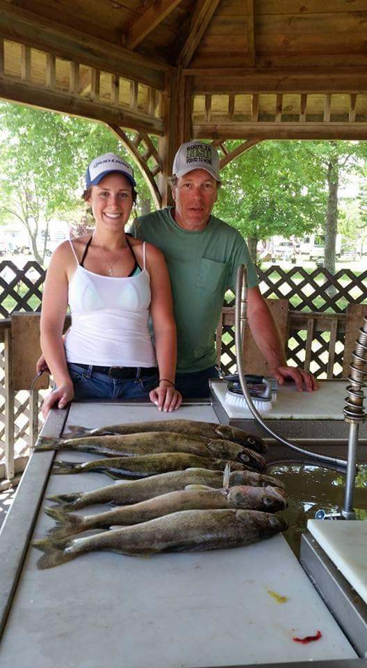 Two people fishing in MI with a 27-inch fish